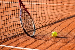 a tennis court with a tennis ball and a tennis racket
